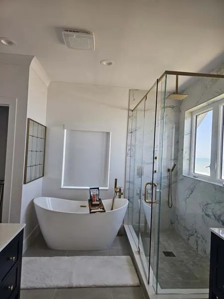Bathroom with a freestanding tub and new lighting