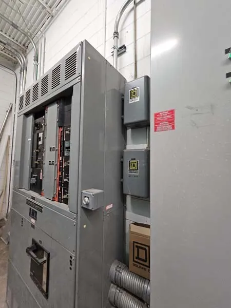 Commercial electrical service equipment on a steel building wall