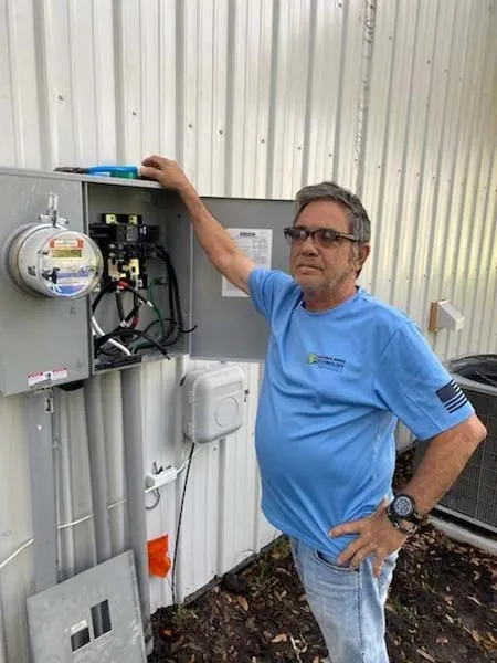 John Bonaccorso beside a meter and service panel he installed on a steel building
